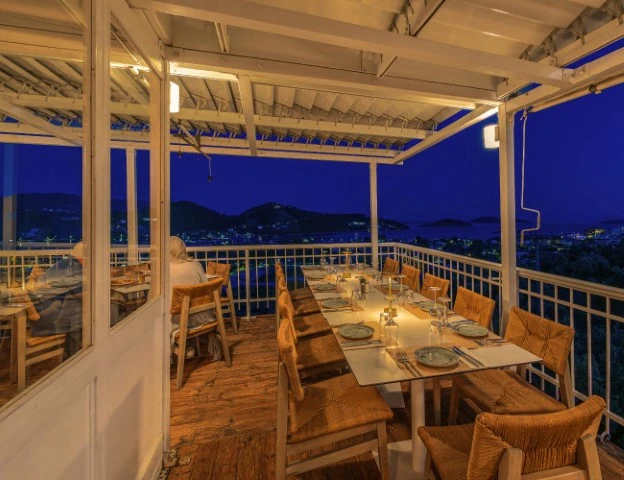 Agnadio Restaurant night scene with skiathos overview